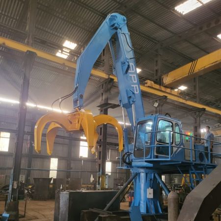 SM Enterprise, Guwahati (Assam) Electric Stationary Material Handler featured 9 meters boom reach with 0.5m3 hydraulic orange peel grab bucket.